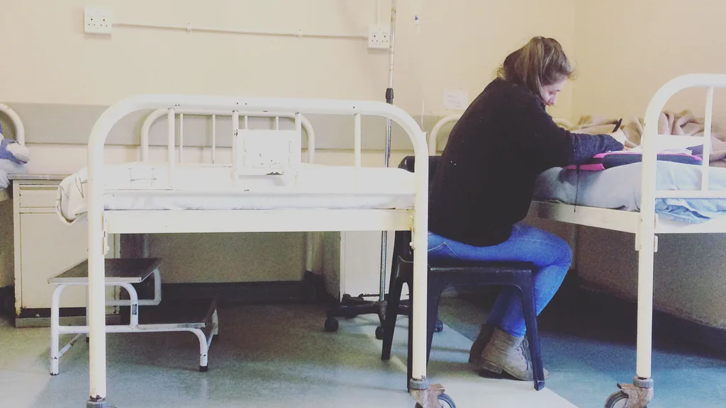 A therapist guiding a patient through a shoulder exercise