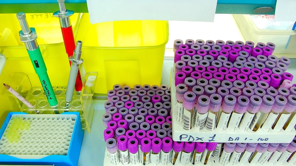 A researcher using a pipette at a laboratory bench