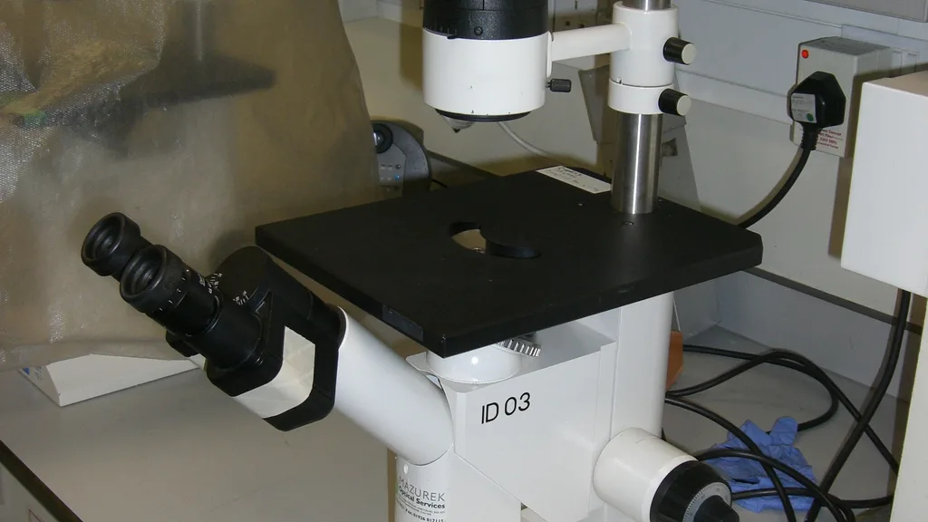A researcher working at a microscope