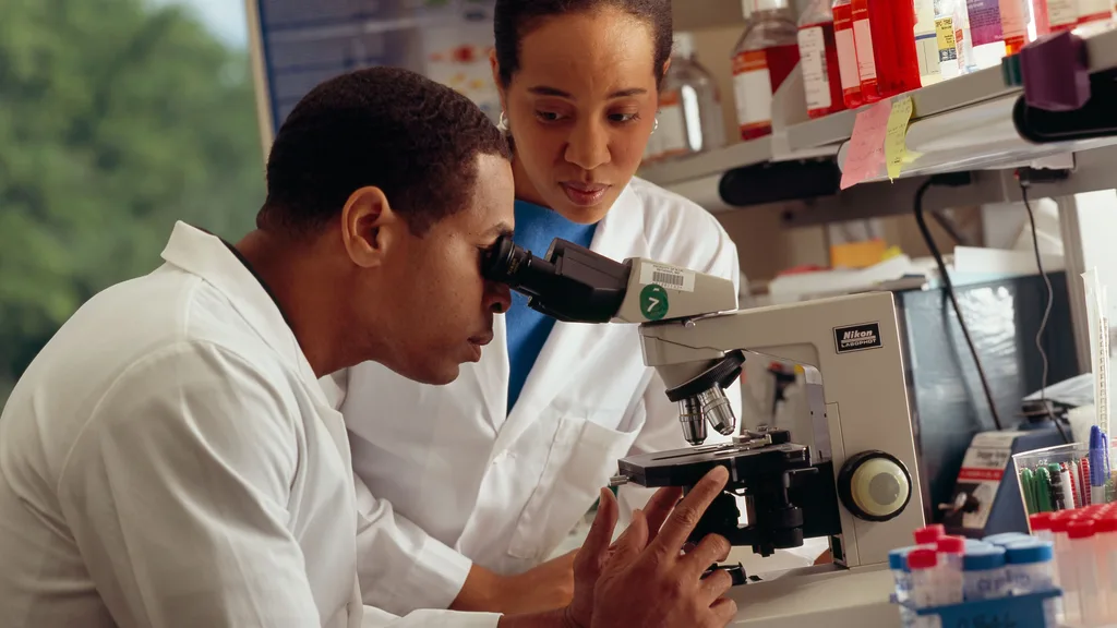 A researcher working at a microscope
